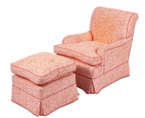 A fully upholstered armchair:, in a coral coloured trailing foliate design with loose cushion seat, together with a matching 