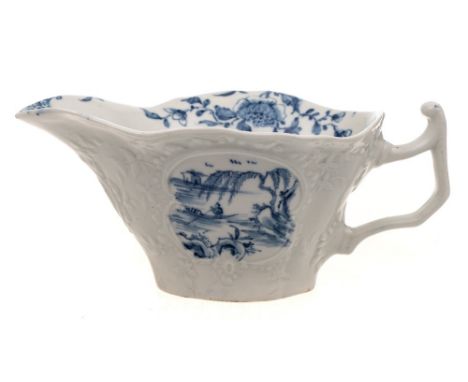 A rare First Period Worcester sauceboat: of deep quatrelobed form with angular handle and moulded scroll and foliate cartouch