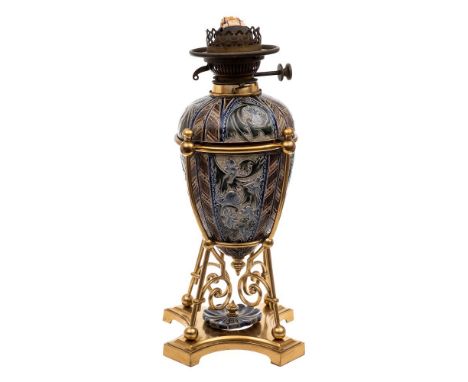 A Doulton Lambeth stoneware oil lamp: the base and reservoir decorated by Mark V. Marshall with panels containing fairy folk,