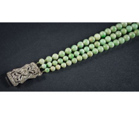 A graduated jade bead three-string necklace: the individually knotted beads graduate from 5mm to 10mm and on rectangular past