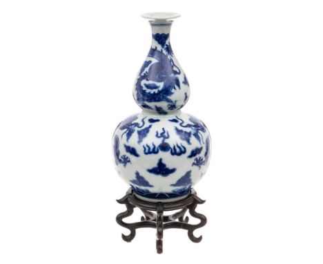 A Chinese blue and white double gourd 'Dragon' vase: painted overall with dragons chased flaming pearls amongst cloud scrolls