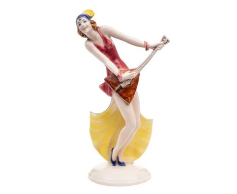 A William Goebels Art Deco figurine: modelled as an elegant balalaika player on a domed circular base, impressed marks and FF