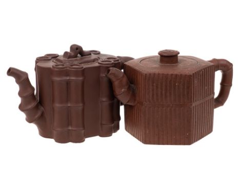 Two Chinese Yixing stoneware teapots: one of dark brown hue and with bamboo moulded decoration and bamboo moulded handle and 