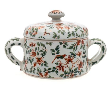 A Dutch polychrome delftware two-handled posset pot and cover: with mushroom finial, painted in iron-red and green with birds