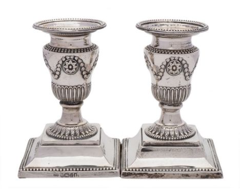 A pair of Victorian silver desk candlesticks, maker Harrison Brothers & Howson, Sheffield, 1876: with neo-classical urn-shape