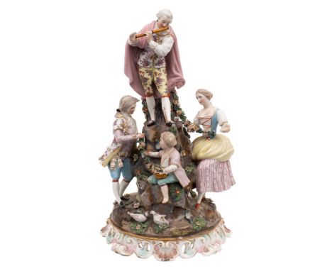 A late 19th century Dresden porcelain 'Musical' group: in the form of a standing gallant playing the flute, three companion f