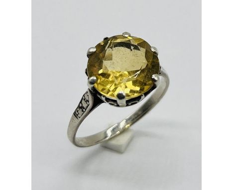 A citrine ring set in white metal