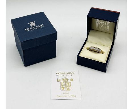 A Royal Mint DNA anniversary ring set in 9ct gold with diamonds- weight 3.9g