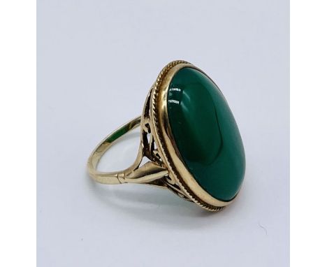 A 9ct gold ring set with a large green stone