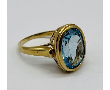 A 9ct gold ring set with vibrant blue topaz