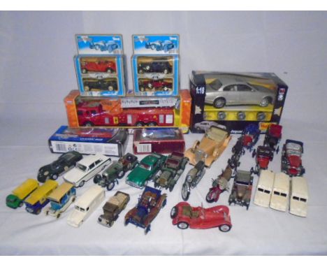 A collection of die-cast and plastic vehicles including Team Power fire truck, Maisto Jaguar S-Type, Teamsterz City claasic b