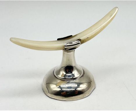 A vintage silver knife rest
