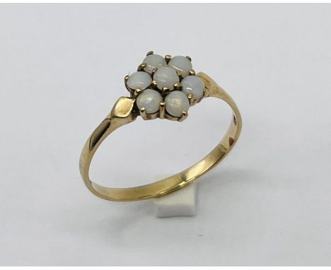 A 9ct gold ring set with a cluster of opals