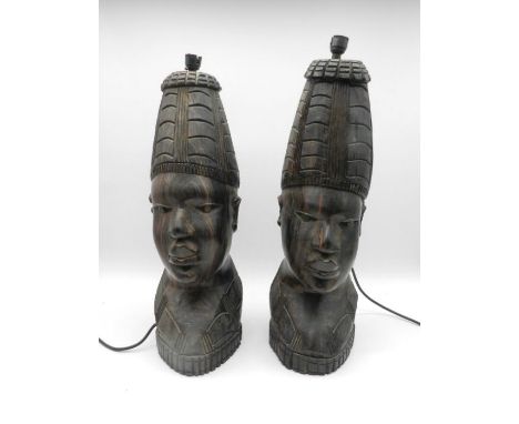 Two lamp bases formed from carved wooden African tribal busts - height 55cm