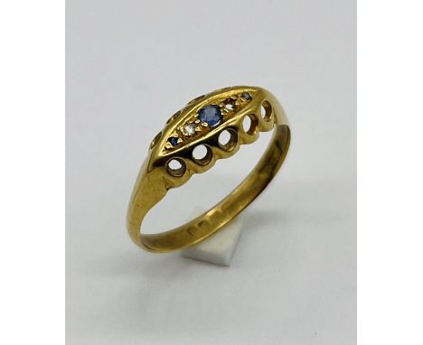 An 18ct gold "boat" ring set with diamonds and sapphire (1 stone missing) total weight 1.8g