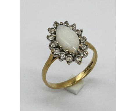 A marquise style opal ring set in 9ct gold