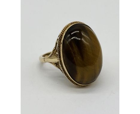 A 9ct gold ring set with tigers eye