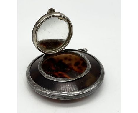 A hallmarked silver and tortoiseshell compact/patch box with integral mirror