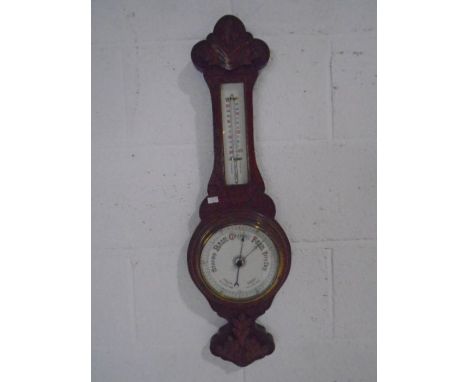 A carved oak banjo barometer