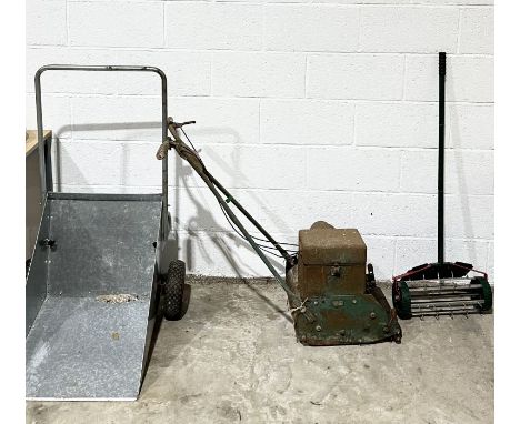 A Webb vintage lawnmower along with a galvanised wheelbarrow and a spiked aerator 