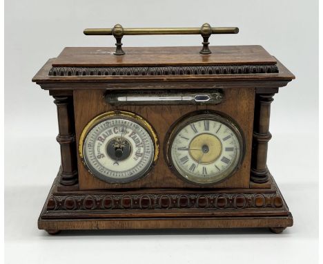 A desktop oak barometer and clock combination with central mercury thermometer