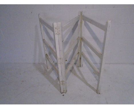 A vintage white painted clothes rail
