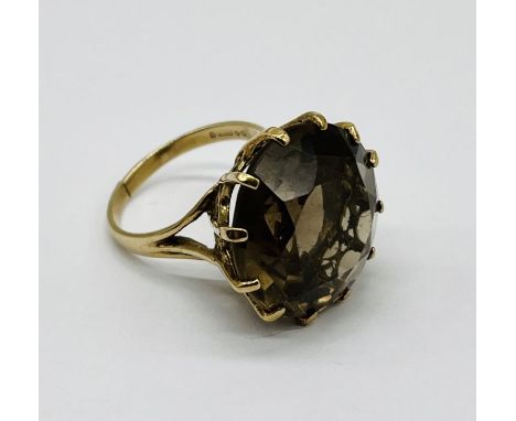 A 9ct gold ring set with a large smoky quartz