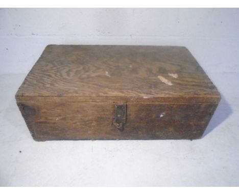 A large rope handled wooden tool chest, with vintage woodworking tools.