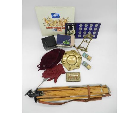 A vintage wooden tripod along with an ornate brass table top easel, brassware, two novelty money banks - 'Dracula' and 'The T