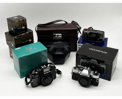 A collection of Olympus cameras, lenses etc including OM10 and OM40 in original boxes with manual, 50mm and 135mm lens, T20 f