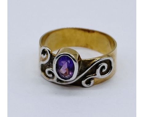 A 9ct gold Celtic influenced ring set with an amethyst, weight 4.8g