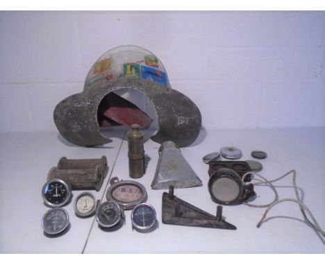 A collection of vintage motorcycle parts including Triumph grips, oil and amp meters. 