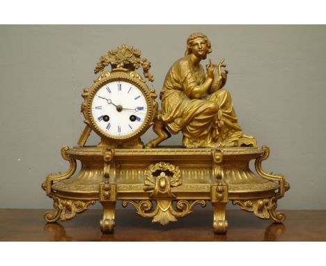 Late 19th/early 20th century gilt metal figural mantel clock, with maiden playing the harp, floral swags and scrolls, W36cm  