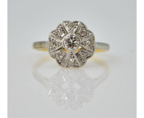 Art Deco platinum set diamond flower cluster ring on 18ct gold shank stamped 18ct.pt   Condition Report  3.1gmsize K Click he