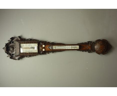 Victorian Black Forest style carved oak stick barometer,register inscribed J.Somalyico & Co. Hatton Garden, London, with ther