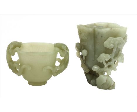 A Chinese jade carving, in the shape of a lingzhi by rocks, surrounded by bats, peaches and further lingzhi branches, the sto