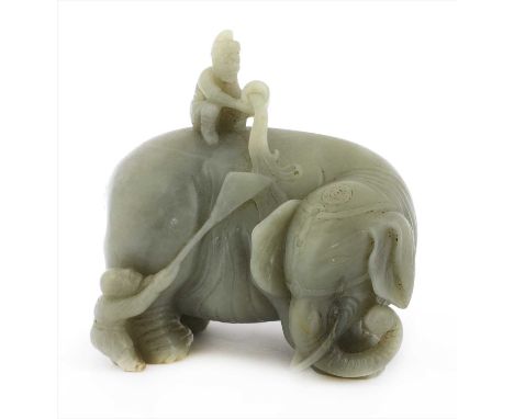 A Chinese jade carving, of an elephant turning its head to the right, a foreigner seated on its back pouring water from a buc