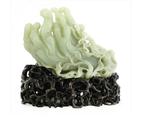 A Chinese jade carving, of monkeys and a boy holding a ruyi sceptre, seated on a finger citron pierced and carved with leaves