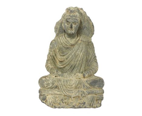 A Gandhara grey schist Buddha, 4th century, the seated figure with legs crossed and his hands resting in his lap in Dhyana mu