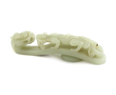 A Chinese jade belt hook, of typical form, one end with a dragon's head, the other with a chilong climbing up the body, the s