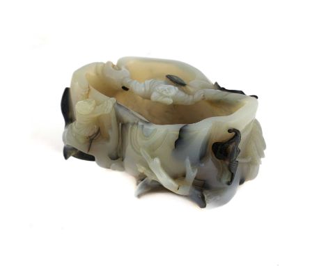 A Chinese agate washer, Qing dynasty (1644-1911), in the shape of a tree trunk with leaves in white, carved with boys climbin