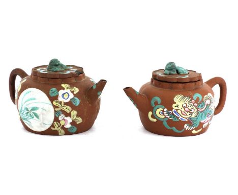 Two Chinese Yixing zisha teapots, 20th century, of lobed circular form, one enamelled with a Buddhist lion playing with a bro