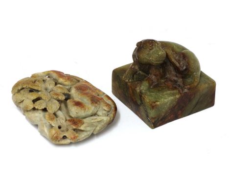 A Chinese hardstone seal, of a lion seated on a square plinth, its head turned to the left, 6.2cm long, and an hardstone boul