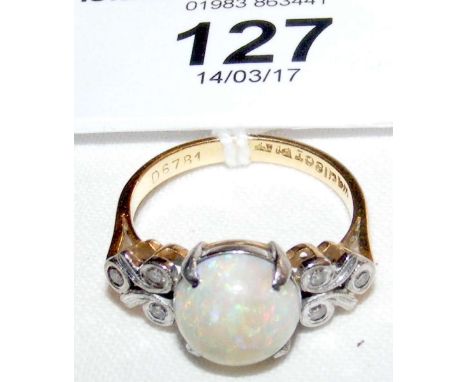 Opal and diamond ring in gold setting