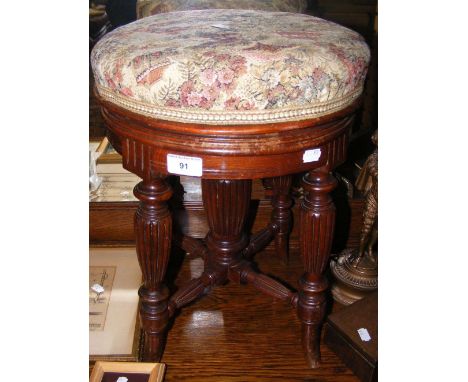 Antique revolving piano stool on fluted support