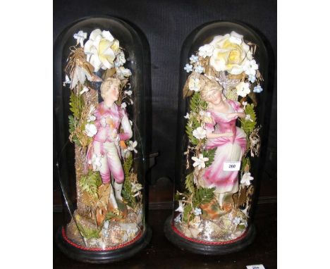A pair of Victorian ceramic figurines under glass domes - 52cm high