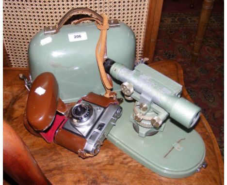 A cased theodolite, together with a vintage camera