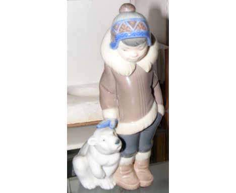 A Lladro figure of Eskimo with Polar Bear cub, in original box