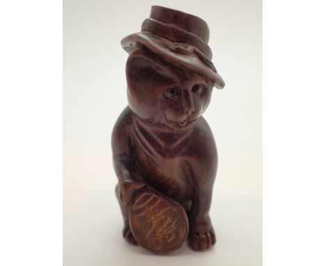 Signed wooden netsuke of a cat in a hat