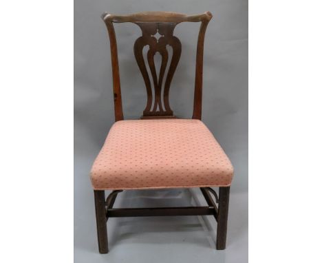 A George III Chippendale style mahogany dining chair, with undulating top rail, pierced vase splat back, stuff over seat, on 